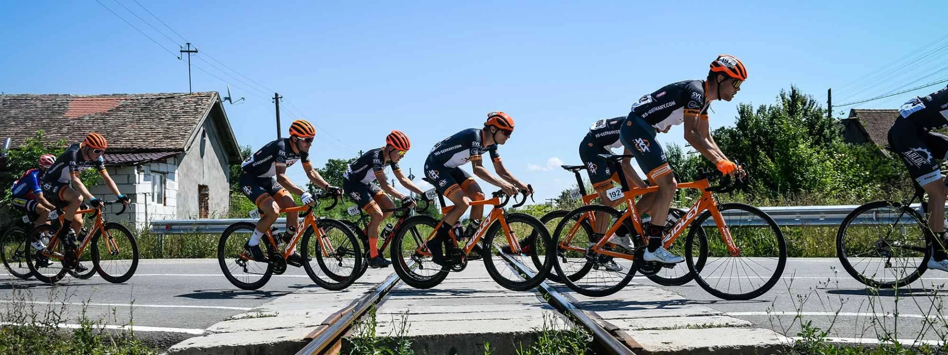Cyclists on bicycles cross a railroad crossing. Cyclists on bicycles cross a railroad crossing.